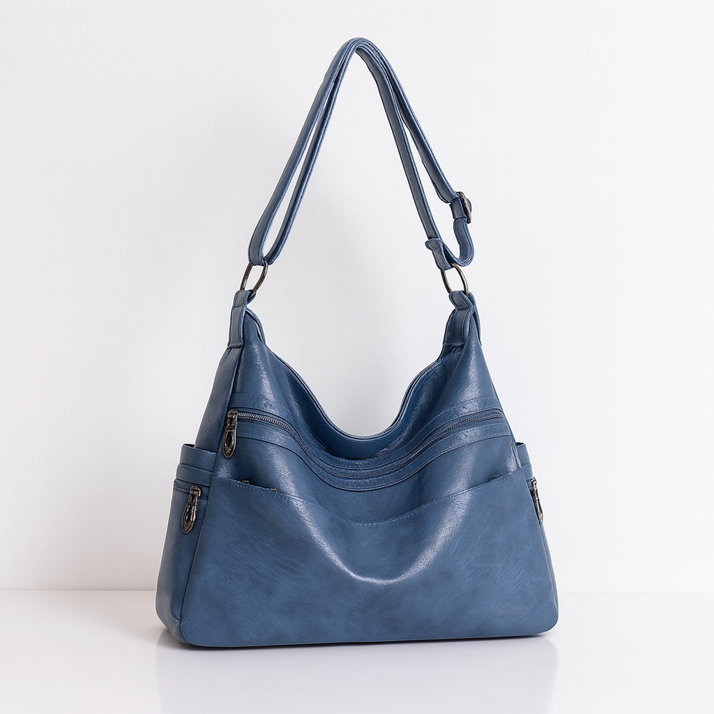 Stijlvolle handtas van hoogwaardig PU-leer met meerdere handige vakken, afgebeeld in de blauw. De tas heeft een elegant design met ritssluitingen en verstelbare schouderbanden, en is ook verkrijgbaar in espresso.