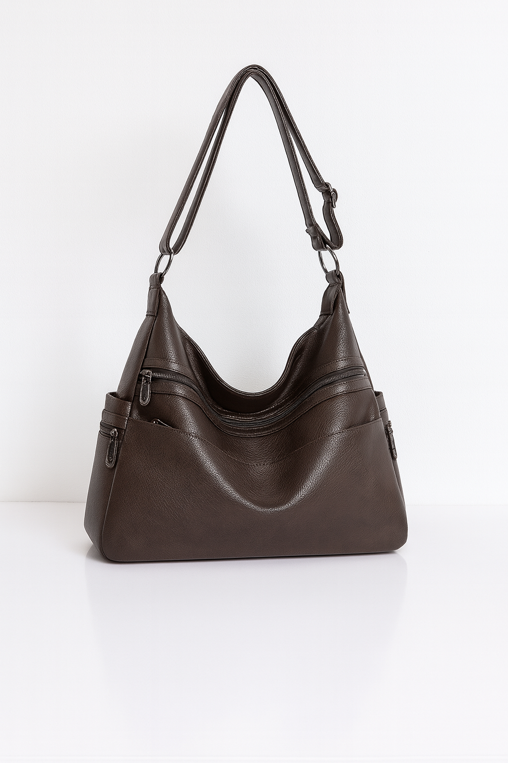 Stijlvolle handtas van hoogwaardig PU-leer met meerdere handige vakken, afgebeeld in de kleur espresso. De tas heeft een elegant design met ritssluitingen en verstelbare schouderbanden, en is ook verkrijgbaar in blauw.