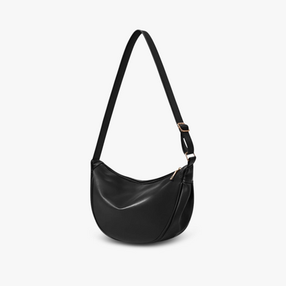 Minimalistische crossbody in vegan leer met verstelbare band en moderne silhouette, ideaal voor dagelijks gebruik.