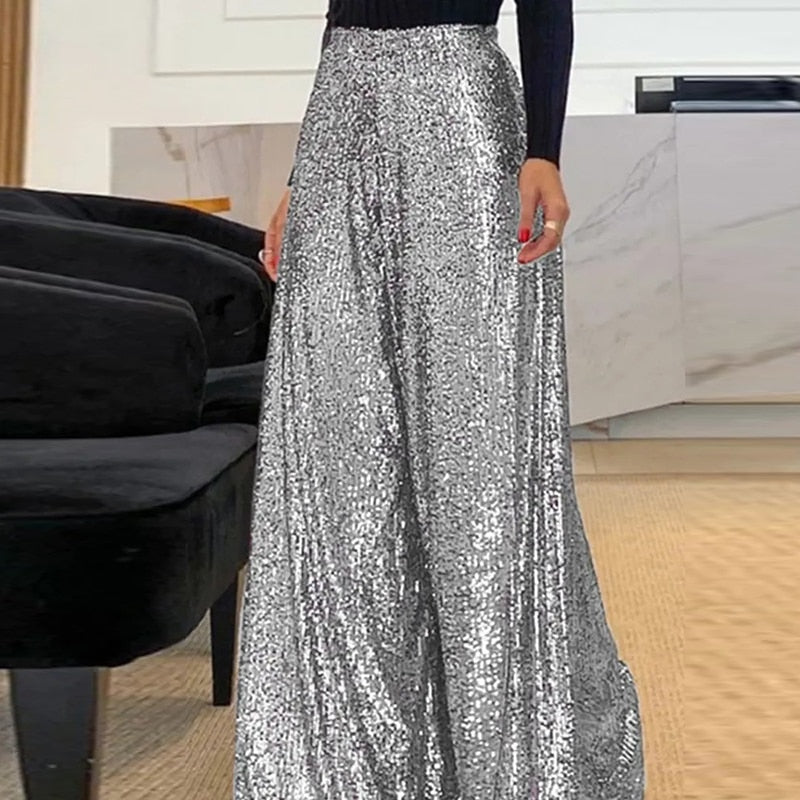 Rosalinde wide-leg broek: stijlvolle broek met schitterend paillettenontwerp, high-waisted pasvorm en vloeiend silhouet. Perfect voor avondfeesten, evenementen en feestelijke gelegenheden. Verkrijgbaar in Donkerbruin, Zwart en Zilver, in maten S t/m 5XL. Combineer glamour en comfort met de Rosalinde en laat je outfit stralen. Bestel nu en voeg een vleugje sprankeling toe aan je avondgarderobe!