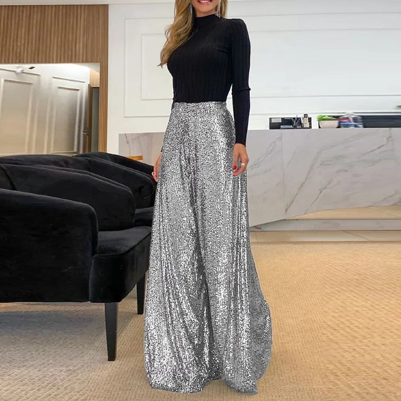 Rosalinde wide-leg broek: stijlvolle broek met schitterend paillettenontwerp, high-waisted pasvorm en vloeiend silhouet. Perfect voor avondfeesten, evenementen en feestelijke gelegenheden. Verkrijgbaar in Donkerbruin, Zwart en Zilver, in maten S t/m 5XL. Combineer glamour en comfort met de Rosalinde en laat je outfit stralen. Bestel nu en voeg een vleugje sprankeling toe aan je avondgarderobe!